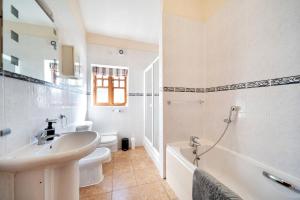 a bathroom with a sink and a tub and a toilet at Converted Barn - Super King beds, Parking, WiFi in Hockwold cum Wilton +36 photos