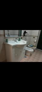 a bathroom with a sink and a toilet at Sogno vesuviano 4 in Torre del Greco +17 photos