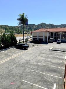 a parking lot with a car parked in front of a building at Castaic Inn Six Flags Valencia in Castaic +11 photos