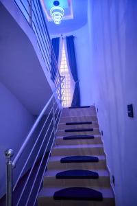 a set of stairs in a building with a window at BROOKLYN HoTEL in Benin City