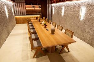 a long wooden table and chairs in a room at Hashtag 98 Hotel By Jalo in Medellín +94 photos