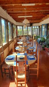 a row of tables and chairs in a restaurant at Paldoa in Pichilemu