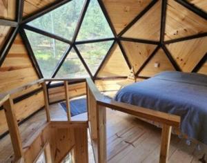a large wooden room with a bed in a cabin at Hongos mágicos in San Mateo Río Hondo