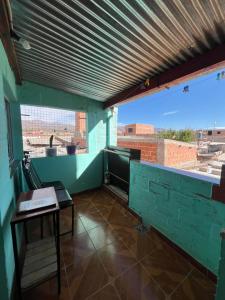 a room with a table and a view of a building at HOSTAL LUCERO in Humahuaca