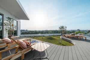 a deck with benches and tables on a building at THE TSUBAKIMORI Hotel & Residence in Chiba
