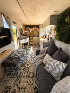 a living room with a couch and a kitchen at The Stallion in Sturminster Newton