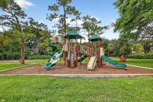 a playground with slides in a park at Pet Friendly-Walk to PGA Resort in Palm Beach Gardens