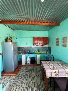 a kitchen with a refrigerator and a table in it at HOSTAL LUCERO in Humahuaca