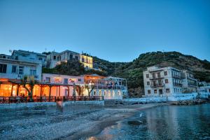 a group of buildings next to a body of water at Ikaria Therma Blue in Agios Kirykos