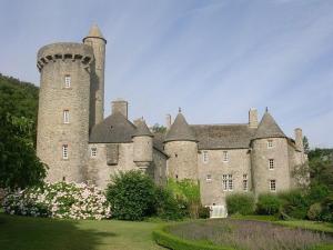 a large castle with a tower on top of it at Moulin à Blé in Urville-Nacqueville