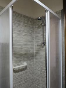 a shower with a glass door in a bathroom at Le Pietre Antiche in Castiglione dʼOrcia
