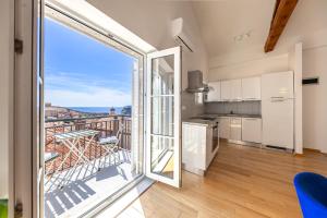 a kitchen with a large glass door leading to a balcony at Whispering Views House Old Town in Dubrovnik