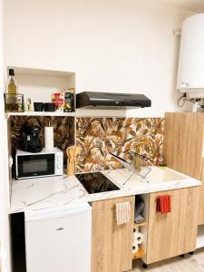 a kitchen with a sink and a counter top at Studio Chaleureux in Langon