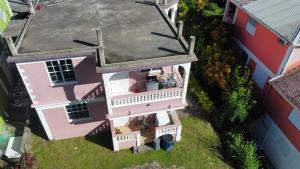an overhead view of a pink house with a balcony at vacation home in Roseau