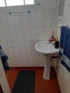 a bathroom with a white sink and a blue towel at casa charme e praticidade in Campos do Jordão +16 photos