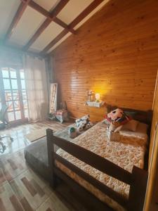 a bedroom with a bed in a wooden room at Pieza con vista al mar in La Serena