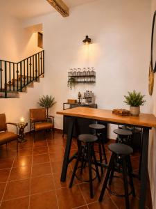 a bar with stools and a table in a room at Refúgio No16 Ocean Air & Rooftop Flair in Albufeira