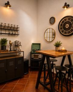 a kitchen with a table and a clock on the wall at Refúgio No16 Ocean Air & Rooftop Flair in Albufeira +32 photos