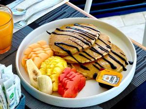 a bowl of food with fruit on a table at Hotel Barrio Latino in Playa del Carmen