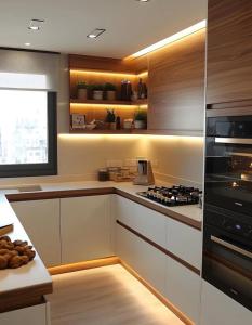 a kitchen with white cabinets and a stove top oven at Elia Serenity House in Anarita