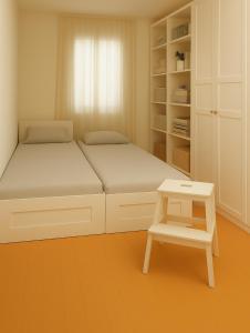 a small bedroom with two beds and a stool at PepinA'S Home in Martigny-Ville +8 photos