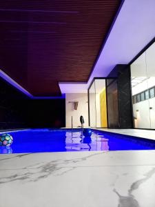 a swimming pool with blue lighting in a building at Golden in Cochabamba