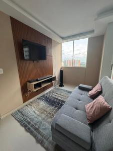 a living room with a couch and a flat screen tv at Barranquilla Prime Apartment in Barranquilla