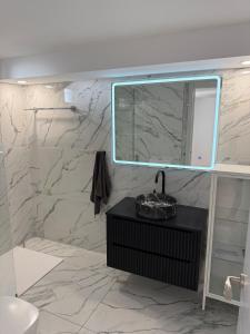 a bathroom with a sink and a mirror at Casa Tul Studio Apartment in Maspalomas +15 photos