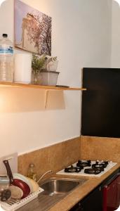 a kitchen with a sink and a stove at Stay Central Malta in San Ġwann