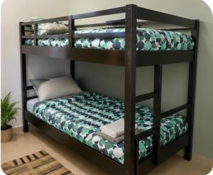 a black bunk bed with a cushion on the bottom shelf at Stay Central Malta in San Ġwann