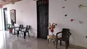 a group of chairs in a room with a door at Hotel Rios in Garzón