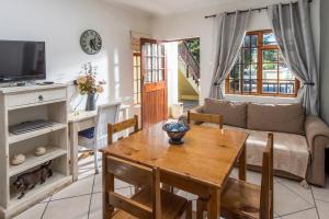 a living room with a table and a couch at Algoa Guest House Summerstrand in Port Elizabeth