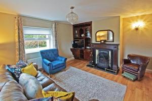 a living room with a couch and a fireplace at 4 Bed in Beara oc-i437 in Adrigole