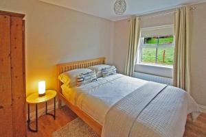 a bedroom with a bed with a candle on a table at 4 Bed in Beara oc-i437 in Adrigole