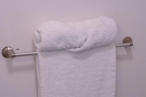 a towel hanging on a towel rack in a bathroom at Modern Private 2-Bedroom Styld, Spacious & Comfy-Modern New 2-Bedroom Stylish, Spacious, Comfy & Nicely Furnished - Full Privacy in St. John's +27 photos