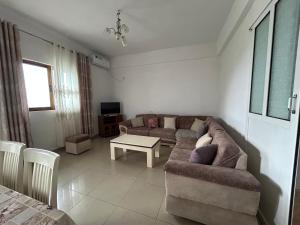 a living room with a couch and a table at Villa Neimi in Ksamil
