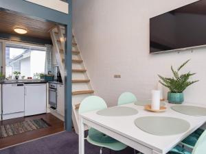 a kitchen and dining room with a white table and chairs at 4 star holiday home in Væggerløse in Bøtø By