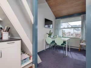 a kitchen and dining room with a table and chairs at 4 star holiday home in Væggerløse in Bøtø By