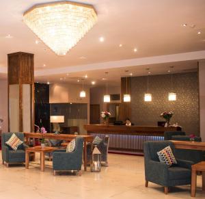 a lobby with chairs and a waiting room with a chandelier at Talbot Hotel Clonmel in Clonmel