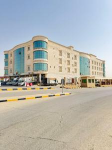 an empty parking lot in front of a large building at Bohovibes in Buraydah