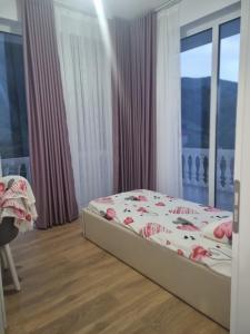 a bedroom with a bed and a large window at Kalanar villa in Elbasan +16 photos