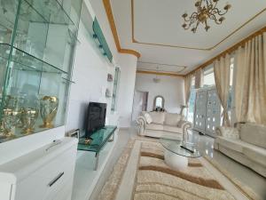 a living room with a couch and a table at Kalanar villa in Elbasan