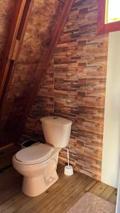 a bathroom with a toilet in a attic at Tierra Viva By Astrid in Cucunubá