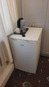 a small refrigerator with water bottles on top of it at Ansty homes in Wyken