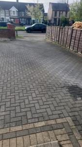 a brick driveway with a fence in a residential neighborhood at Ansty homes in Wyken