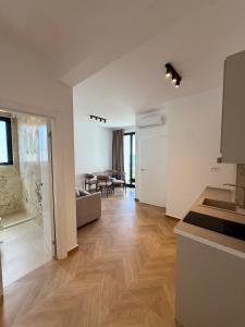 a kitchen and a living room with a table at Maresa 7 in Čanj