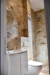 a bathroom with a toilet and a sink and a shower at Maresa 7 in Čanj