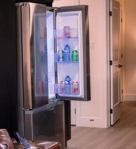 an empty refrigerator with its door open in a room at Modern Private 2-Bedroom Styld, Spacious & Comfy-Modern New 2-Bedroom Stylish, Spacious, Comfy & Nicely Furnished - Full Privacy in St. John's
