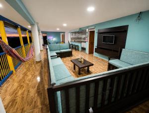 a living room with blue couches and a couch and a table at Finca Hotel Vista Palmar - Eje Cafetero in Quimbaya