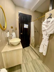 a bathroom with a sink and a mirror and a sink at Royal Ruiz in Ibarra +80 photos